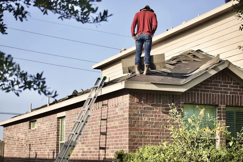Professional roofer working on a residential roof in Lake Mills